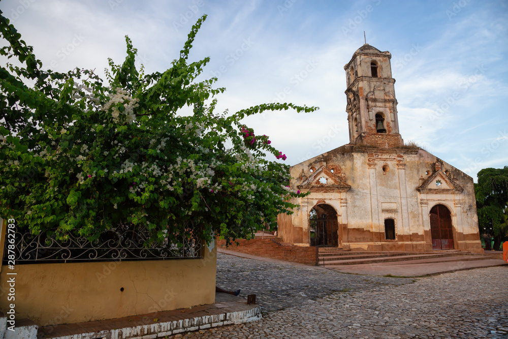 Beautiful View of a Church in a small touristic Cuban Town during a vibrant sunny and cloudy evening before sunset. Taken in Trinidad, Cuba.