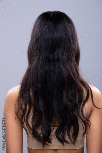 Back side view of Women to show long black curl straight Hair style before after applying hair styling, studio lighting gray background isolated, copy space for text logo