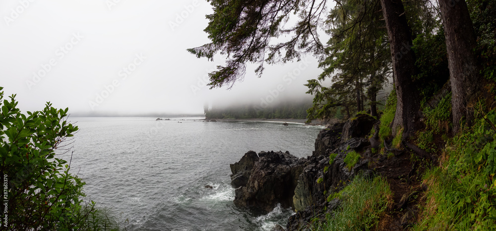 Beautiful Panoramic View of a rocky beach on the Juan de Fuca Trail during a summer sunset. Taken at Sombrio Beach, near Port Renfrew, Vancouver Island, BC, Canada.