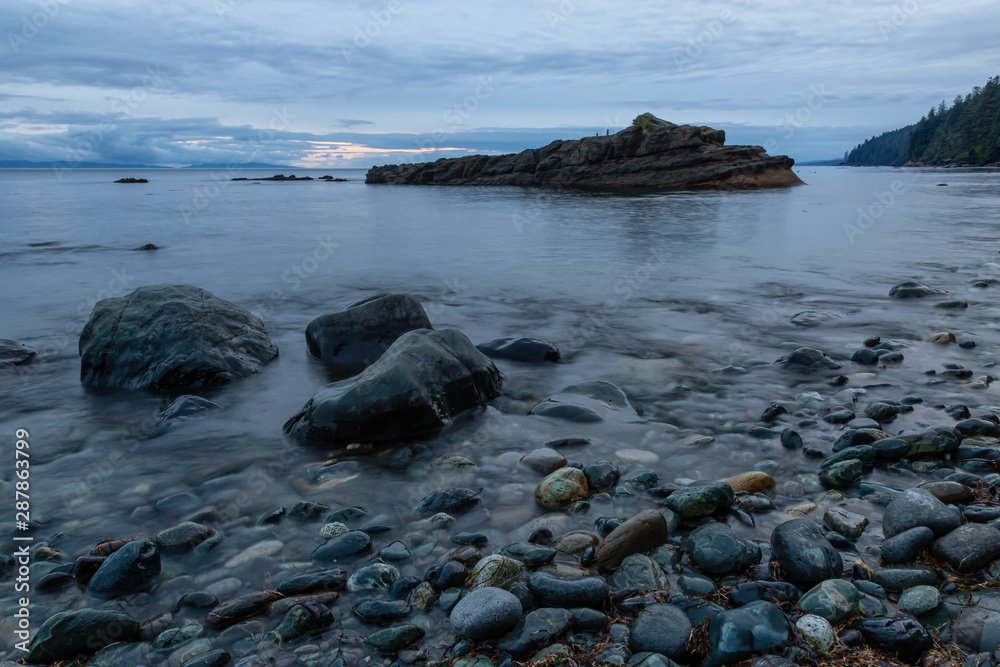 Beautiful View of a rocky beach on the Juan de Fuca Trail during a summer sunset. Taken at Chin Beach, near Port Renfrew, Vancouver Island, BC, Canada.