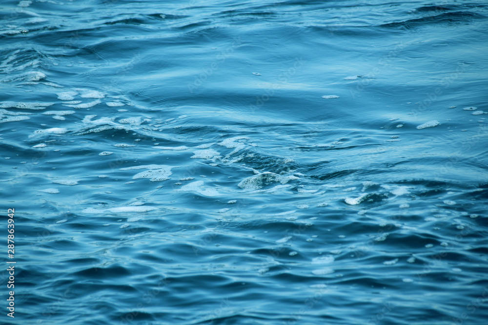 blue sea, ocean waves, water with foam and bubbles, texture, water natural resources concept, close-up, copy space blue sea, ocean waves, water with foam and bubbles, texture, water natural resources concept, close-up, copy space