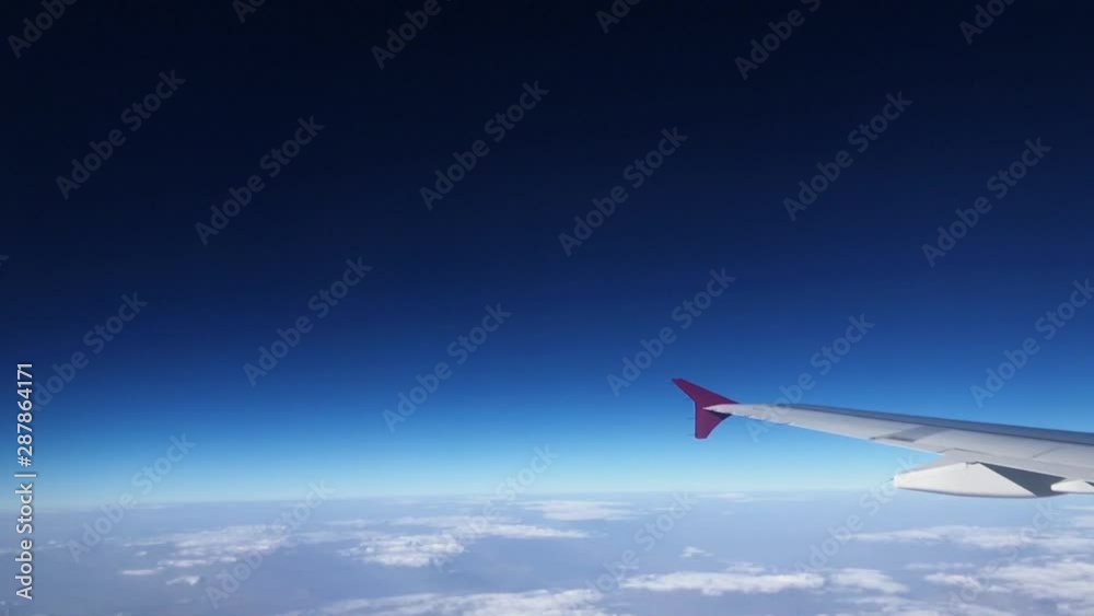 Airplane wing as seen from the passenger's seat.