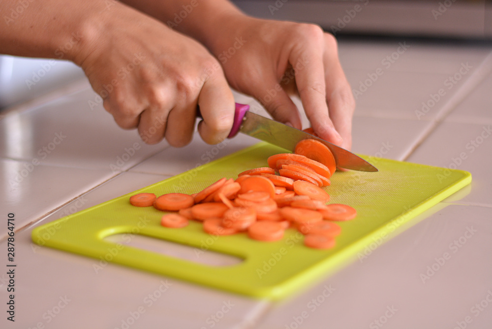 Close-up picture of chopping carrot in the kitchen. Close-up picture of chopping carrot in the kitchen.