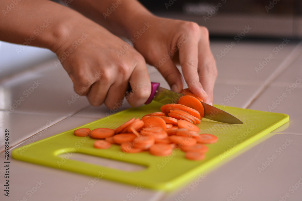 Close-up picture of chopping carrot in the kitchen. Close-up picture of chopping carrot in the kitchen.