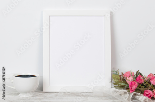 White Frame A4 or letter size mock up for wedding or celebrations anniversary on white table with pink rose, diamond ring, coffee cup decoration and white background