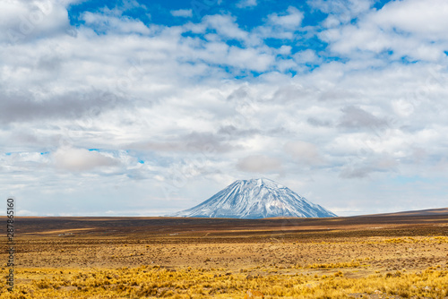The mountain peak of the Misti Volcano towering above the altiplano in the region of Arequipa, Peru. photo