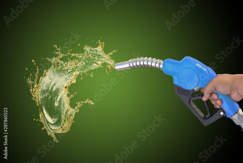 Fototapeta Fuel nozzle Hand holding Oil extracted from the background, clipingpart