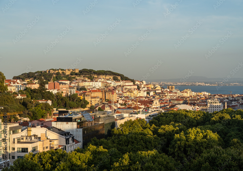Castle and cathedral in downtown Lisbon illuminated by the setting sun