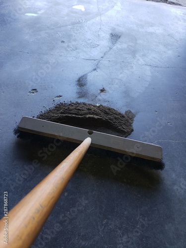push broom sweeping shop floor 