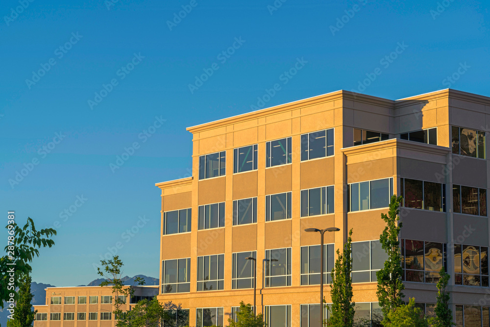 Commercial modern building exterior viewed against blue sky on a sunny day