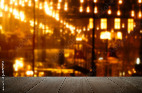 top of wood with blur party orange lamp in bar at dark city night background