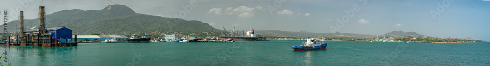 Panoramic view of the electric power station, ships, boats, containers, industrial zone, Puerto Plata harbor, port and cityscape, Dominican Republic