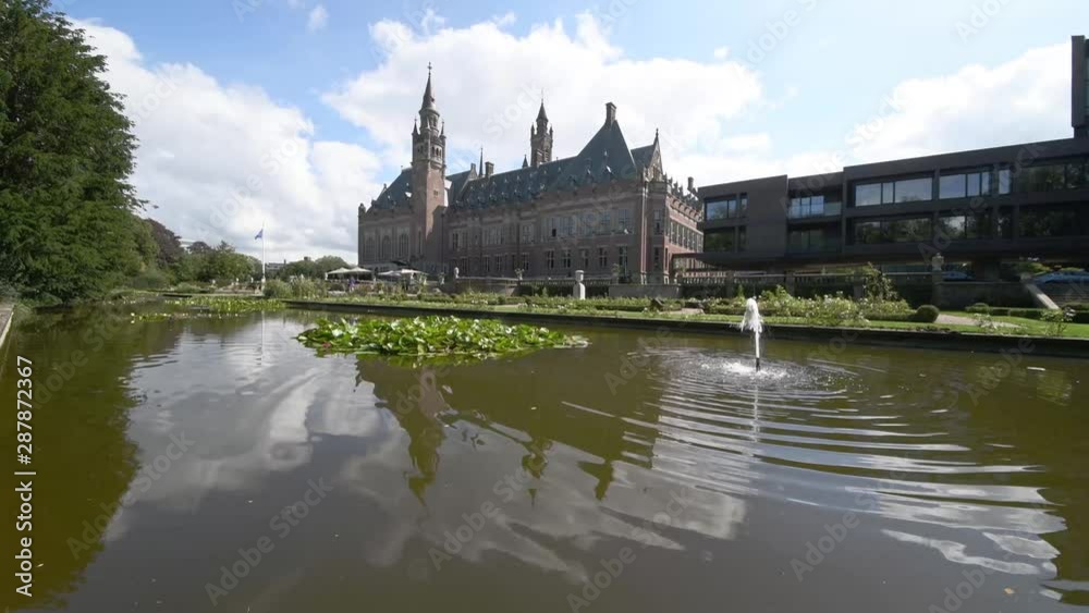 Garden of the Peace Palace, the seat of the International Court of Justice under a sunny and cloudy summer day. Garden of the Peace Palace, the seat of the International Court of Justice under a sunny and cloudy summer day.