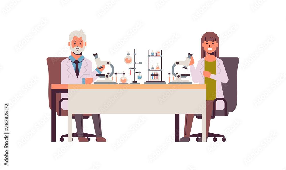 scientists couple using microscope man woman in uniform sitting at table making scientific experiments in chemistry laboratory with test tubes research science concept full length scientists couple using microscope man woman in uniform sitting at table making scientific experiments in chemistry laboratory with test tubes research science concept full length