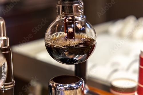 Barista doing Siphon Coffee Brewing