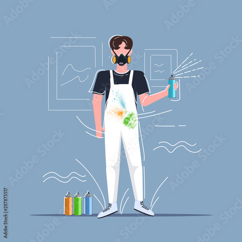male graffiti artist in respiratory mask using aerosol spray man painter in overalls art creativity hobby creative occupation concept full length