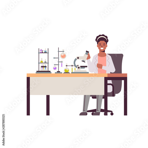 female scientist working with microscope african american woman in uniform sitting at table making scientific experiments chemistry laboratory with test tubes research science concept full length