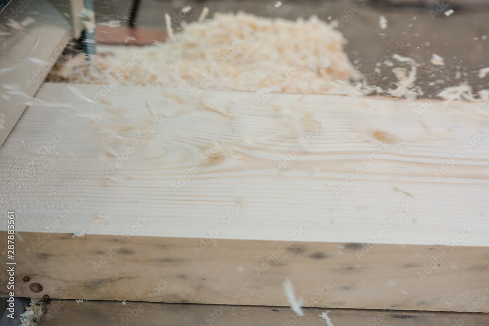 planing boards on a thicknesser. wood shavings. machine for planing wood. carpentry work. joiner's machine. planing boards on a thicknesser. wood shavings. machine for planing wood. carpentry work. joiner's machine.
