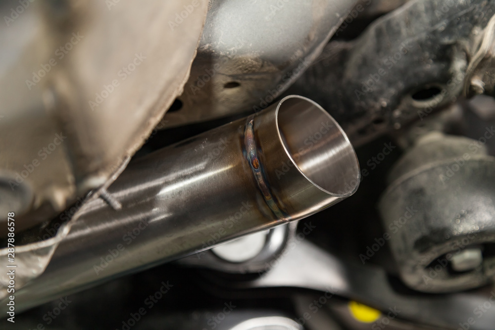 Fabrication and installation of a stainless steel car exhaust pipe with a bifurcation and a louder sound with a color weld under bottom. Tuning and auto service industry.