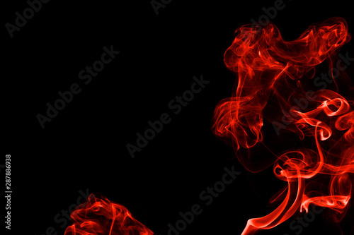 Abstract red orange color smoke isolated on black background. beautiful color smoke wallpaper backdrop. © ezstudiophoto