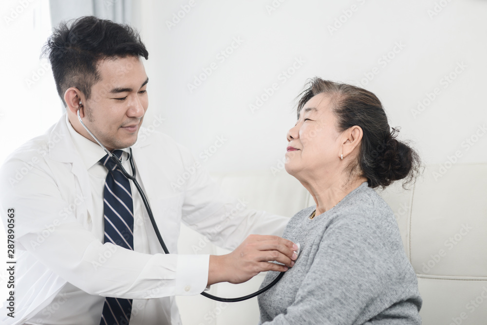 Asian doctor checking up his patient old woman in office. Asian doctor checking up his patient old woman in office.