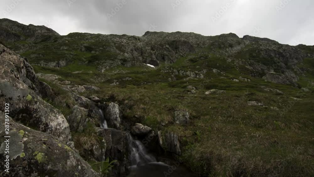 Timelapse of a little stream at the mountain lake Seebodensee at Sustenpass in Switzerland Timelapse of a little stream at the mountain lake Seebodensee at Sustenpass in Switzerland