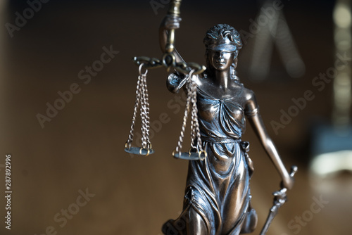 Law and Justice, judge gavel, book with Statue of blind goddess Themis on wooden table.