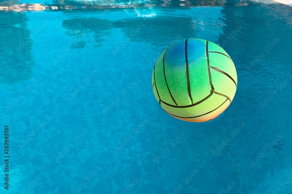 beach volleyball ball in swimming pool. copy space