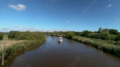 Aerial Drone Footage of a boat along the River Waveney, Norfolk. photo