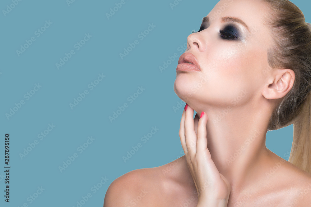 Portrait of a young beautiful woman with healthy and clean skin. Hands touches the neck. Portrait of a young beautiful woman with healthy and clean skin. Hands touches the neck.
