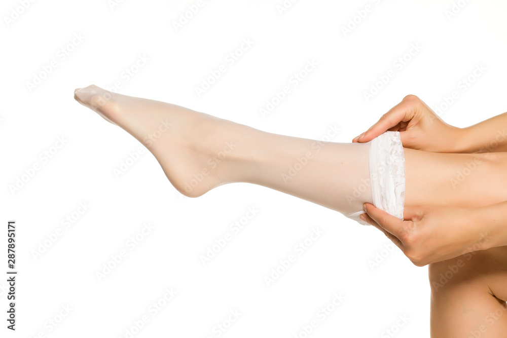 Woman wearing white nylon socks on white background Woman wearing white nylon socks on white background