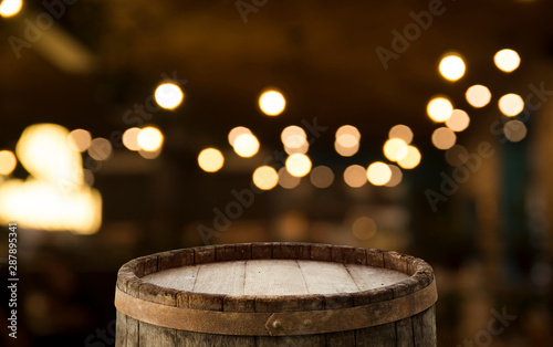 Empty wood table top on blur light gold bokeh of cafe restaurant in dark background © kishivan