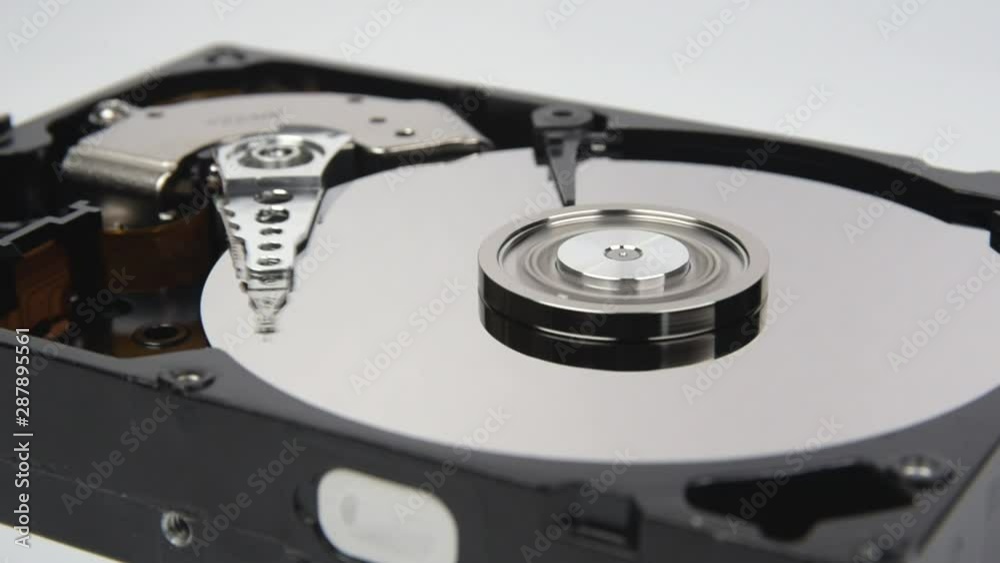 Close-up of the inside of a computer hard disk doing reading and writing. Close-up of the inside of a computer hard disk doing reading and writing.