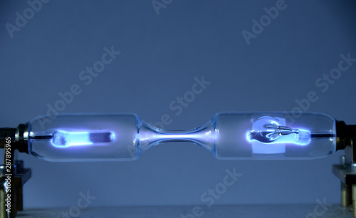 The inert gas Xenon (Xe) seen in a discharge tube emits light due to an electric field.