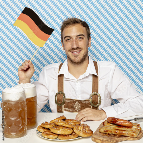 Man with german flag, food and beer