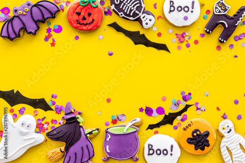 Creepy cookies for halloween treat frame on yellow background top view mockup