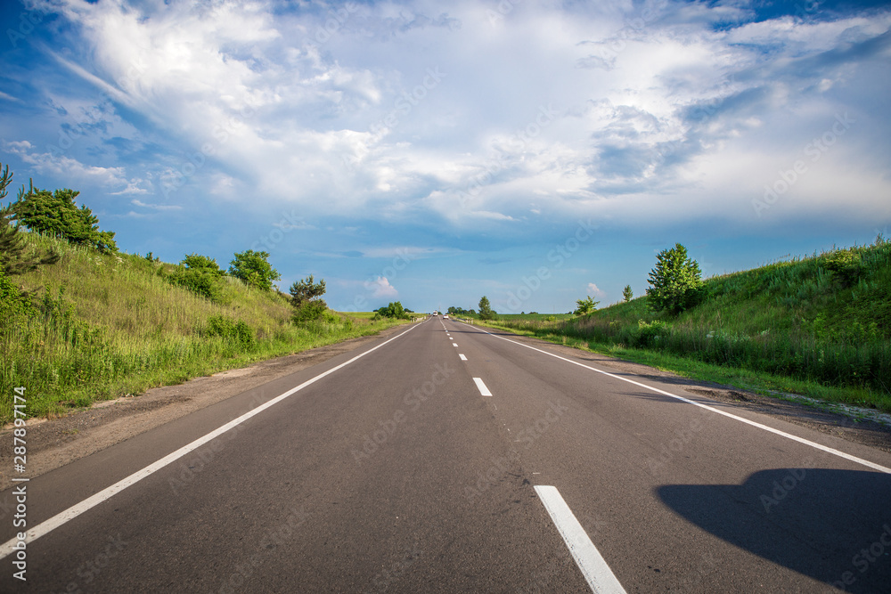 Asphalt highways and mountains under the blue sky