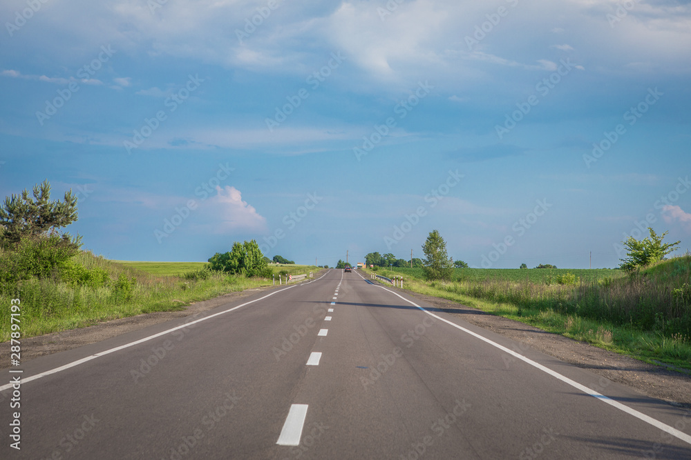 Asphalt highways and mountains under the blue sky