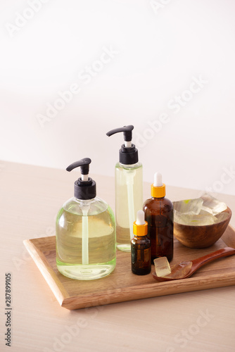 Gel shower and peeled aloe vera on a wooden background