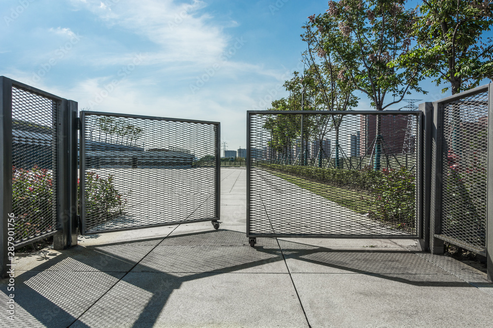Wrought iron gate and stone pillar isolated on white background. Stock