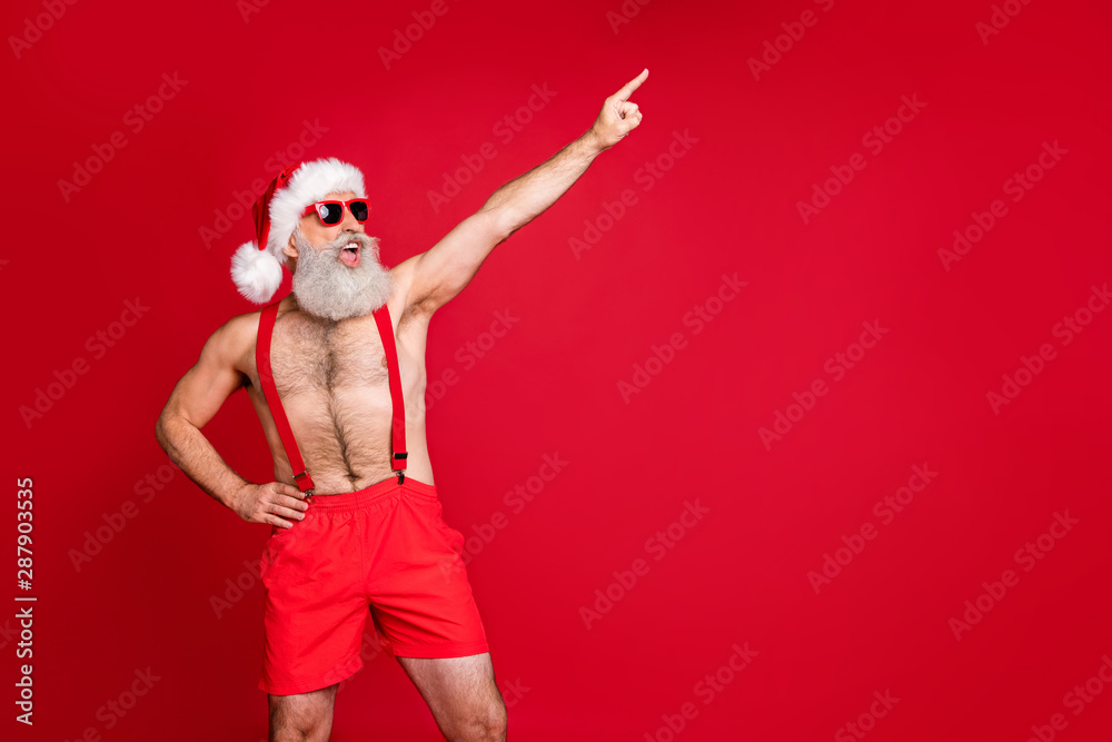 Portrait of his he nice attractive cool cheerful cheery funky positive playful gray-haired man having fun St Saint Nicholas holly jolly pointing finger up isolated on bright vivid shine red background Portrait of his he nice attractive cool cheerful cheery funky positive playful gray-haired man having fun St Saint Nicholas holly jolly pointing finger up isolated on bright vivid shine red background