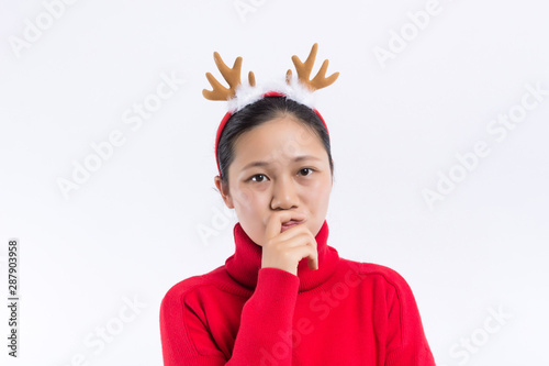 Happy Smiling Hipster Girl in knitted red sweater and hat having fun . Cute girl in glusses with piercing in the nose. Winter or Autumn Warming Up Concept. Dance. Fashion. photo