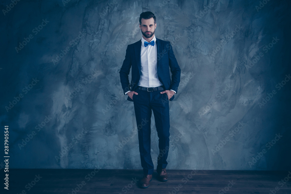Full lenth photo of charming man putting his hands in pockets wearing blazer jacket pants trousers isolated over grey background Full lenth photo of charming man putting his hands in pockets wearing blazer jacket pants trousers isolated over grey background