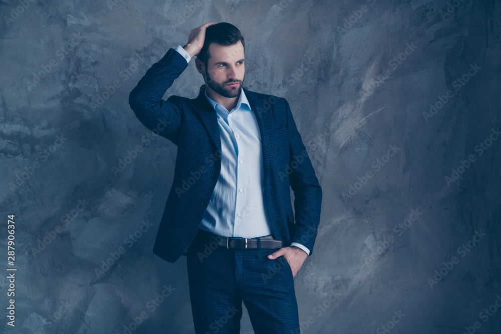 Portrait of elegant man looking with his hand touching head wearing pants trousers formalwear isolated over gray background Portrait of elegant man looking with his hand touching head wearing pants trousers formalwear isolated over gray background