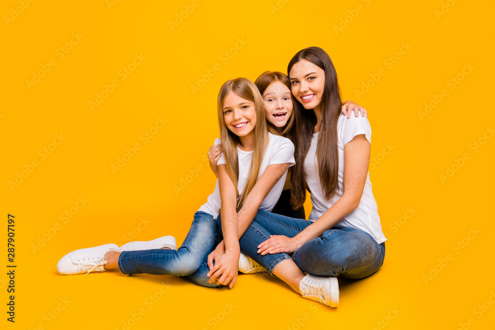 Full size photo of amazing three ladies sitting floor wear casual clothes isolated yellow background Full size photo of amazing three ladies sitting floor wear casual clothes isolated yellow background