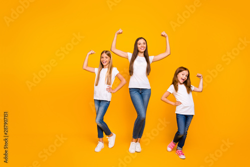 Full length photo of incredible three ladies showing power in arms wear casual clothes isolated yellow background