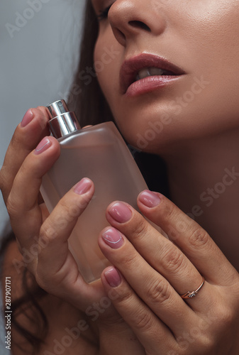 Closeup of a beautiful woman with perfume