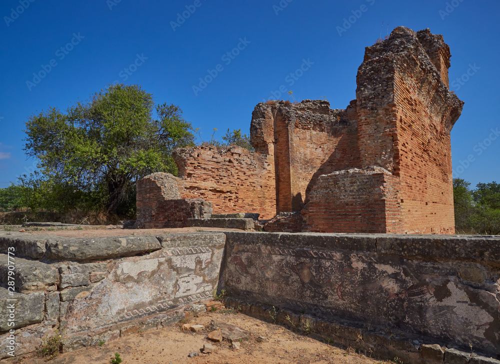 One of the Baths of the Bathing and Spa Complex with its decorative Mosaics and the Water Temple overlooking it at the Roman Ruins of Milreu in Portugal.