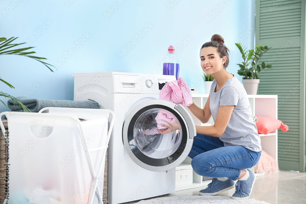 Beautiful young woman doing laundry at home Beautiful young woman doing laundry at home