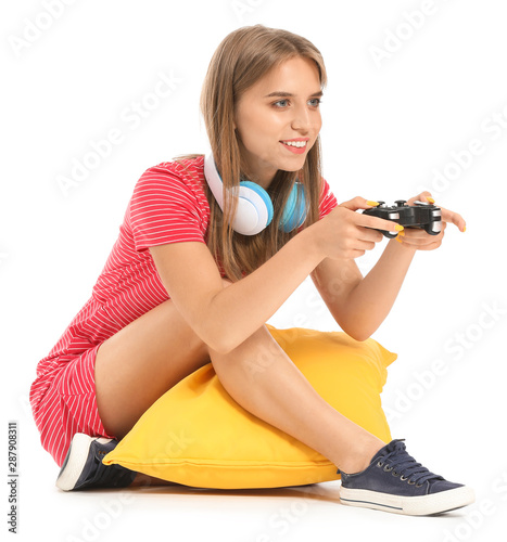 Teenage girl playing video ...